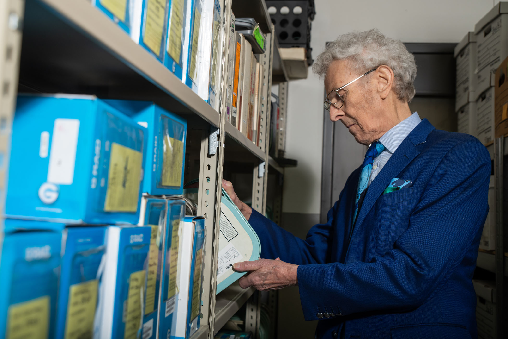 Bob Chitester looks through one of the many programs archived in the Free To Choose Network Archival Media Room. The room houses more than 500 hours of programming.